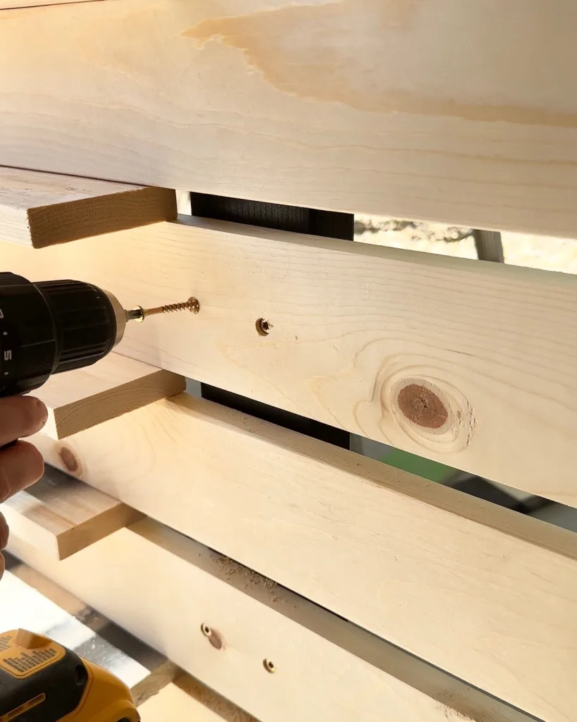 screwing slats to center support of patio wall